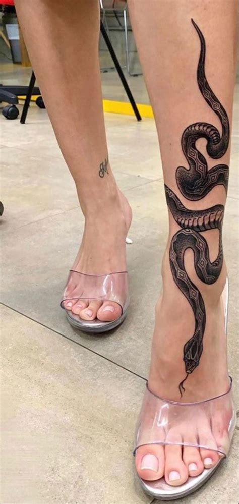 Snake tattoos around leg